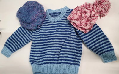 Senior volunteer knits jumpers and hats for newborn bubs
