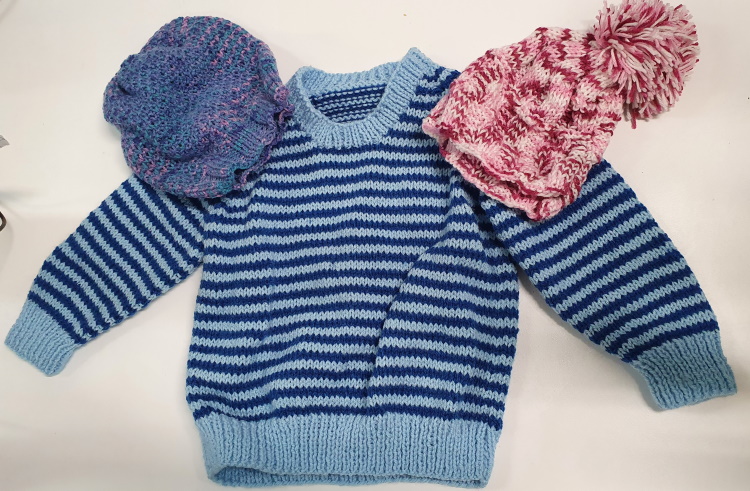 Senior volunteer knits jumpers and hats for newborn bubs